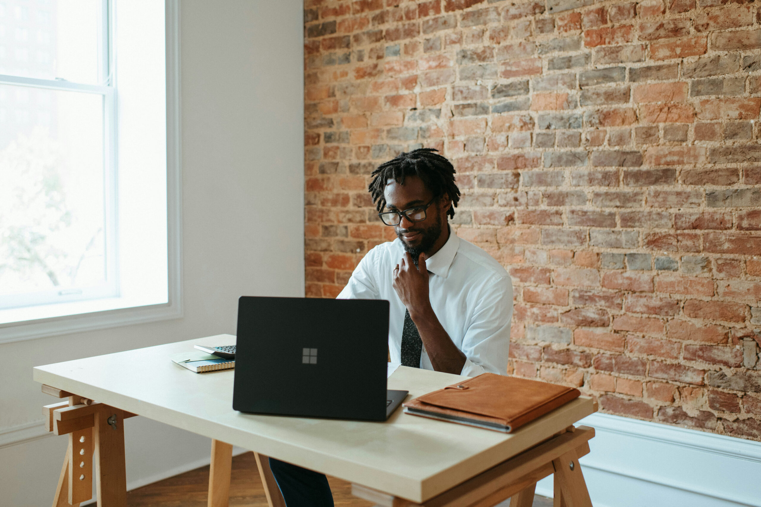 A professional confidently sharing his story online, symbolizing authentic storytelling and overcoming the fear of self-promotion.