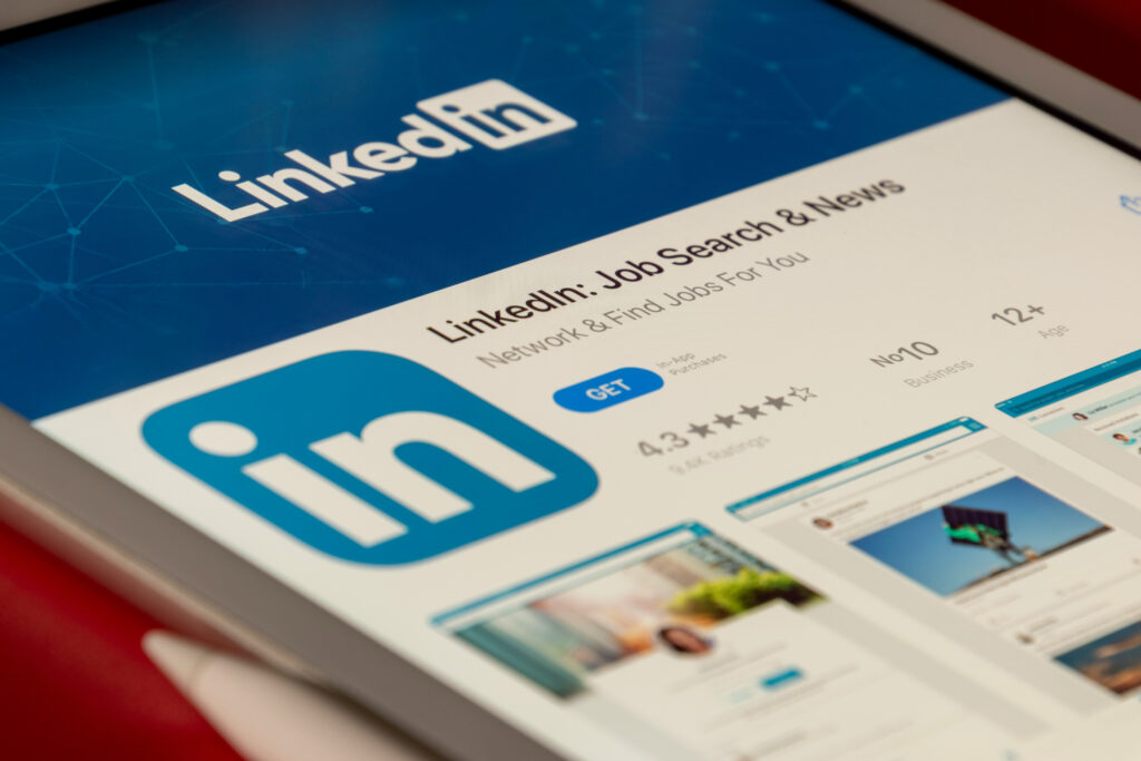 Close-up of a tablet screen displaying the LinkedIn app download page, symbolizing professional networking, engagement, and audience growth on LinkedIn.
