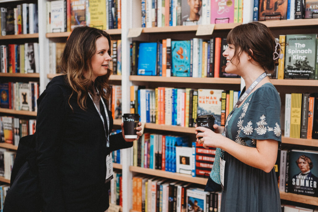 two women discussing self-publishing vs traditional publishing options in a bookstore