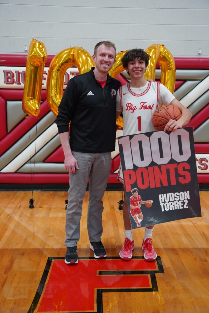 Photo of Hunter Price and player celebrating 1000 points milestone on basketball court, coaching book for coaches.